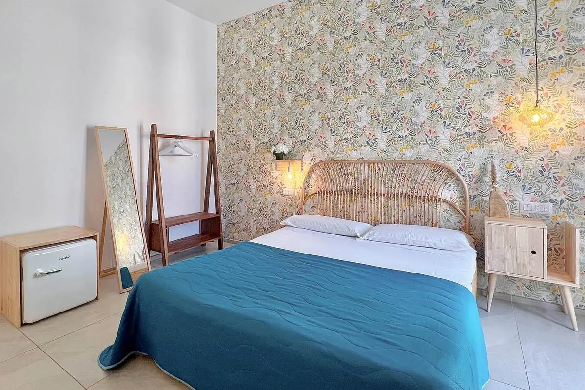 Letto matrimoniale, specchio e minifrigo