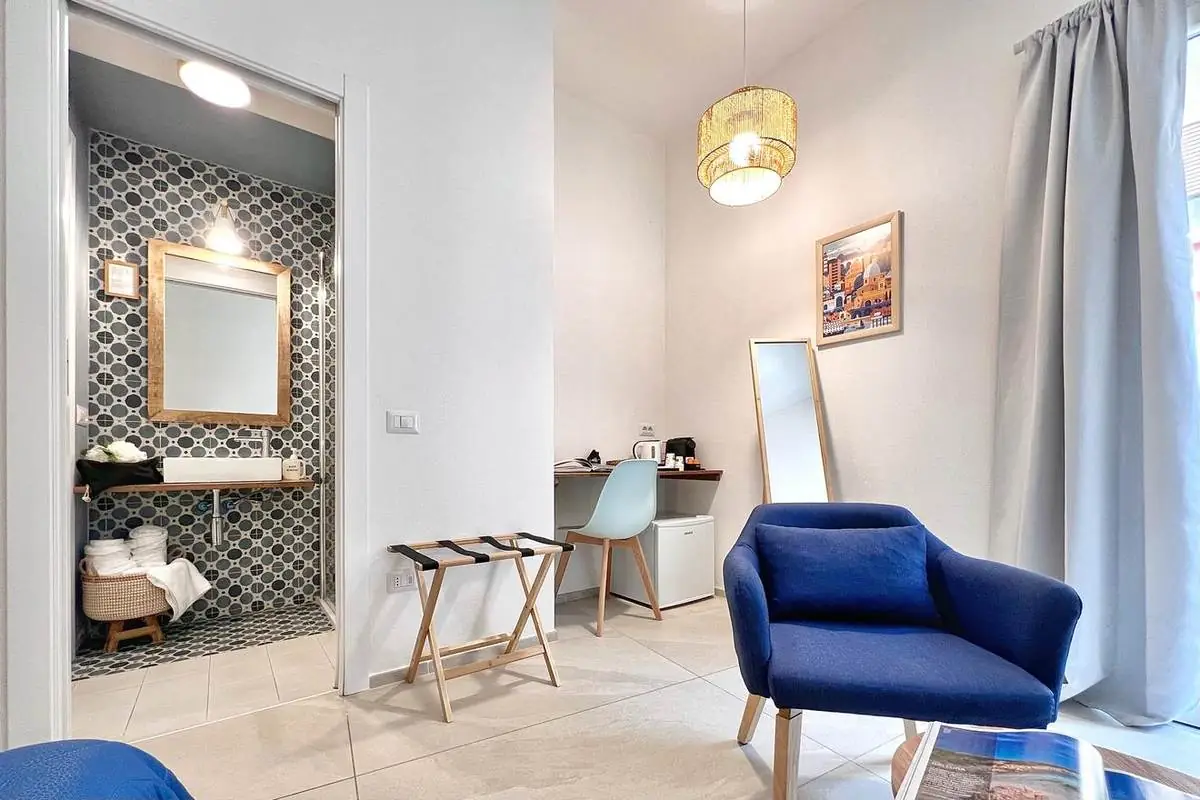 Angolo scrivania, minifrigo e bagno